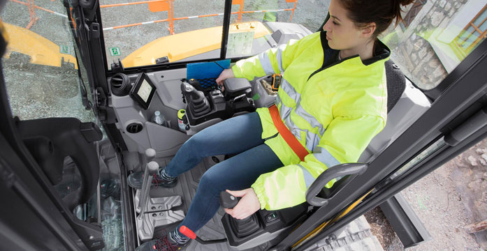 woman in PPE operating excavator